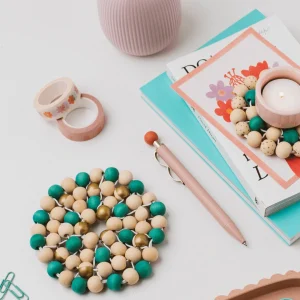 The Beaded Trivet Craft Kit with wooden beads, holly green dye and beading cord for making handmade beaded trivets.