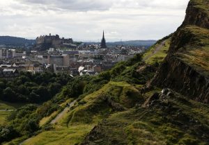 View of Edinburgh Castle from a green hillside walking path