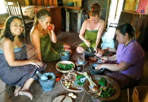 Volunteers cooking with a local woman in Cambodia
