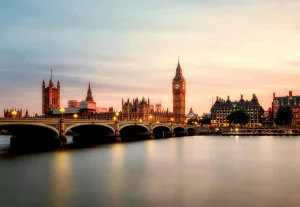 Big Ben and Houses of Parliament at sunset reflected in River Thames, London iconic architecture