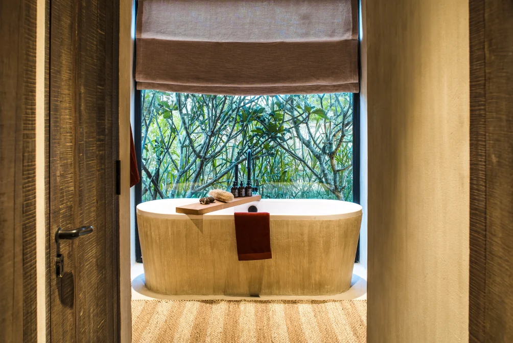 Freestanding bathtub with garden view in a Greenfield Terrace Villa at Zannier Bãi San Hô, Vietnam